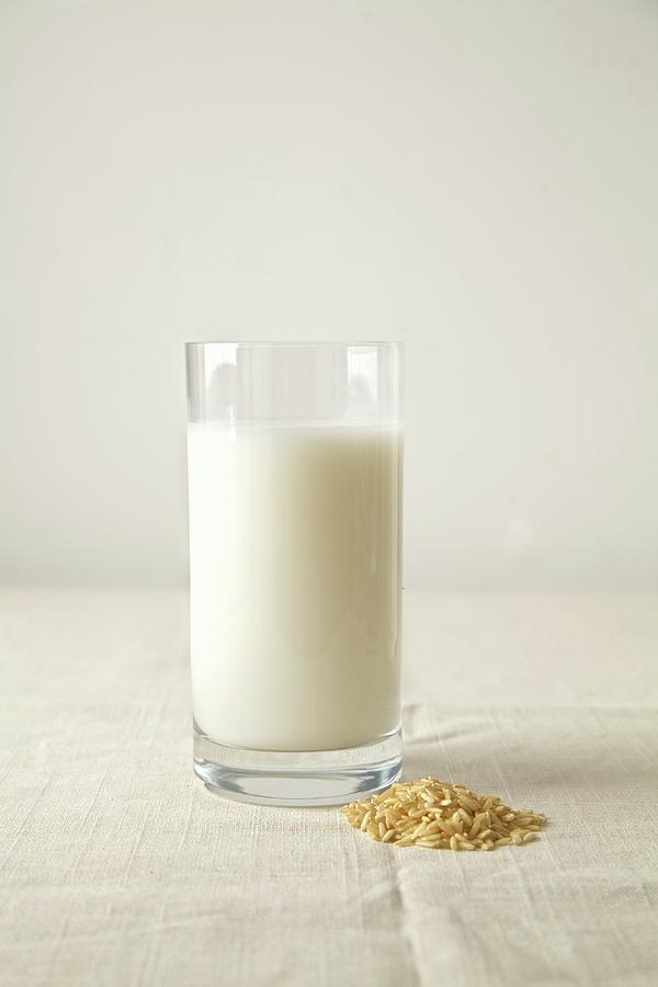 Rice Milk In A Glass Next To Rice Grains Photograph by Andre Baranowski