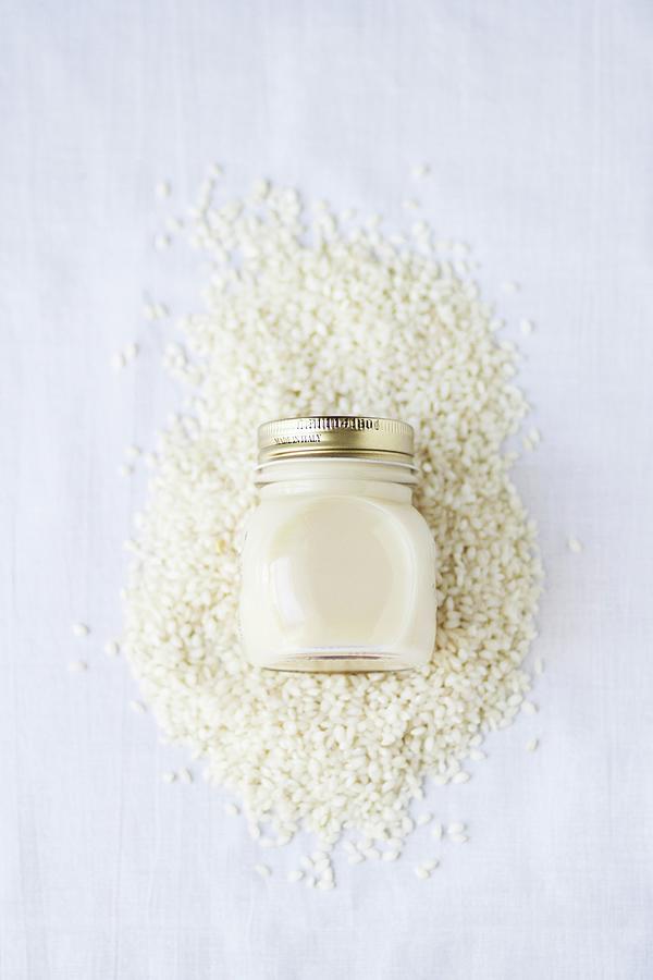 Rice Milk In A Screw-top Jar On A Pile Of Rice seen Above Photograph by Alicia Maas Aldaya