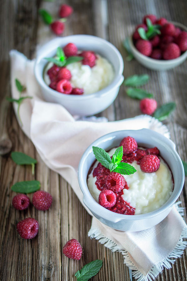 Rice Pudding With Raspberries In Bowls Photograph by Lieberbacken