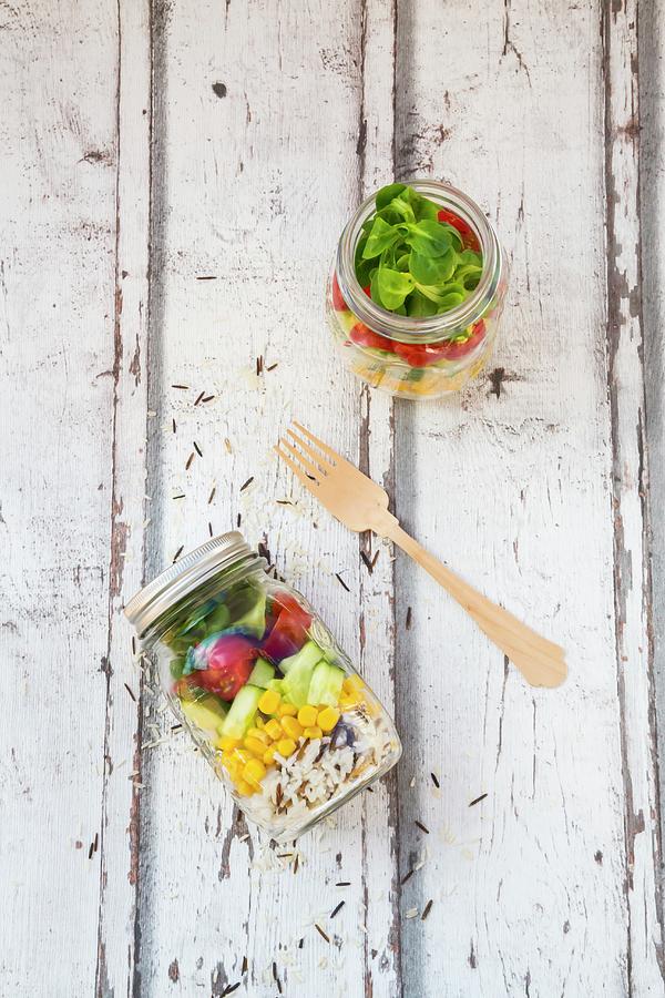 Rice Salad In A Glass Jar With Wild Rice, Sweetcorn, Cucumber, Tomato And Lambs Lettuce Photograph by Larissa Veronesi