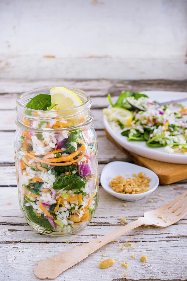 Rice Salad With Baby Leaf Spinach, Carrot, Red Onion, Lemon Vinaigrette And Peanuts In A Glass Photograph by Maricruz Avalos Flores
