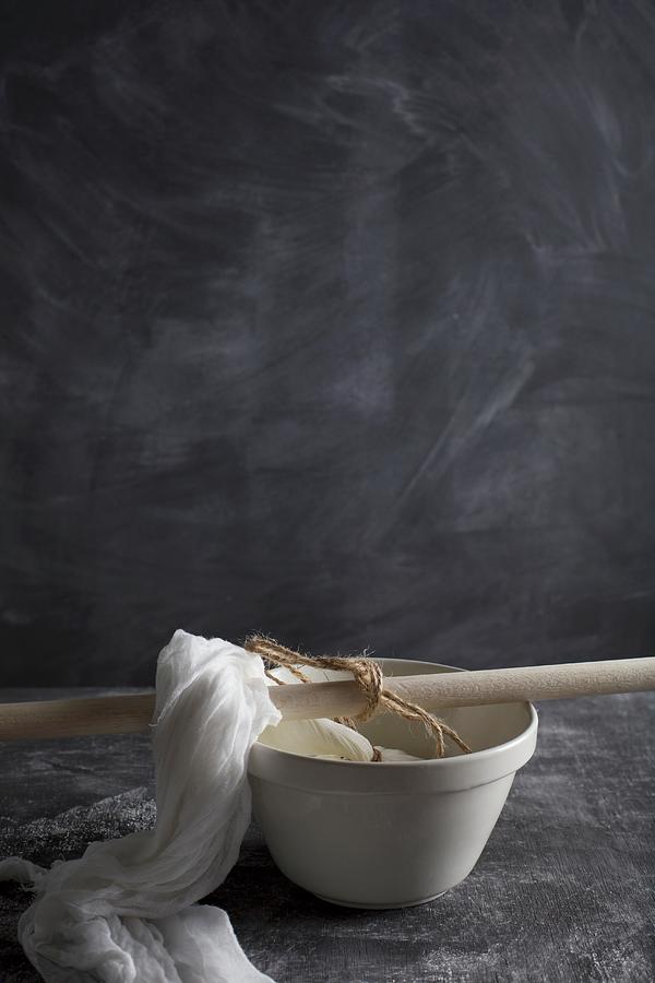 Ricotta In A Cheesecloth Draining Into A Bowl Photograph by Rose Hewartson