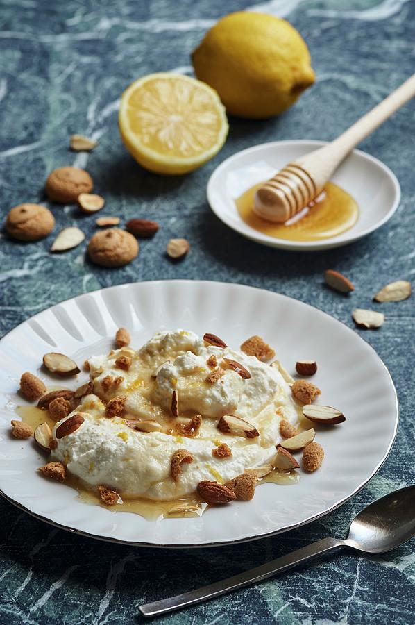 Ricotta Pudding With Lemon, Almonds, Amarettini And Honey Photograph by Ulrike Emmert