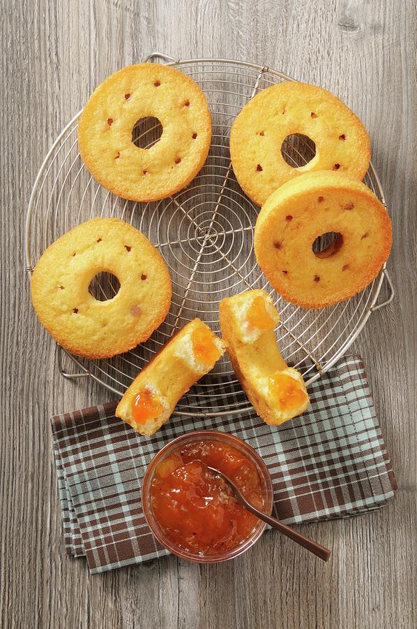 Ring-shaped Cakes With Jam On A Cooling Rack Photograph by Jean-christophe Riou