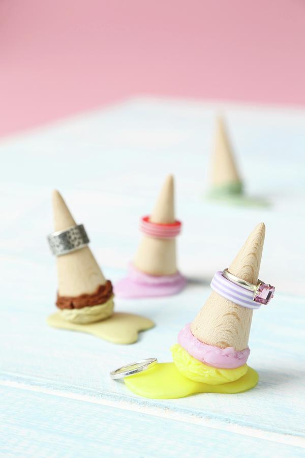 Rings Placed Over Miniature Ice-cream Cones Made From Wood And Modelling Compound Photograph by Thordis Rggeberg