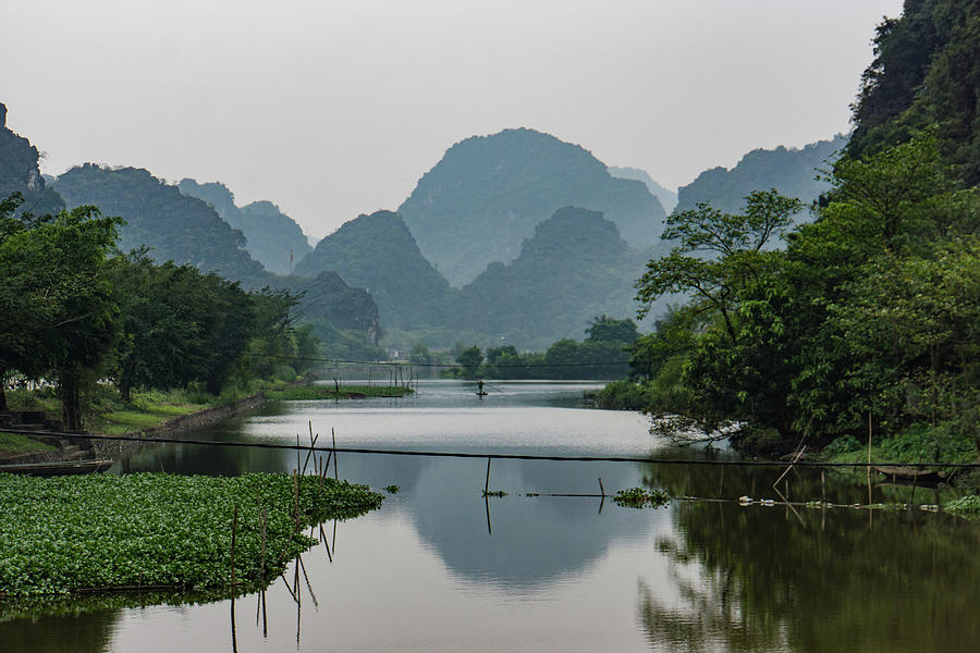 river and limestone mountains in Vietnam Photograph by Ann Moore