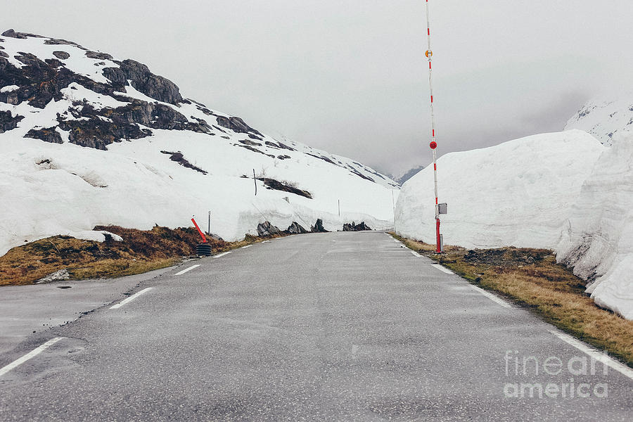 Road surrounded by large blocks of snow Photograph by Joaquin Corbalan
