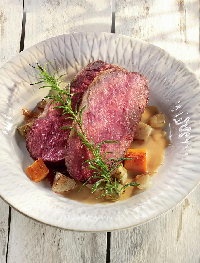 Roast Beef With Root Vegetables And Rosemary Photograph by Jrgen Holz