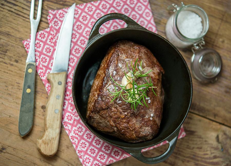 Roast Beef With Rosemary And Garlic In A Pot Photograph by Sebastian Schollmeyer
