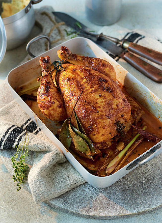 Roast Chicken In A Roasing Tin With A Linen Cloth On A Stone Platter Photograph by Stefan Schulte-ladbeck