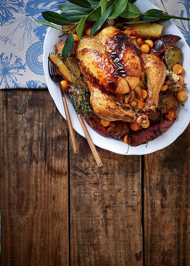 Roast Chicken Stuffed With Thyme And Physalis On A Bed Of Sweet Potato Photograph by Great Stock!