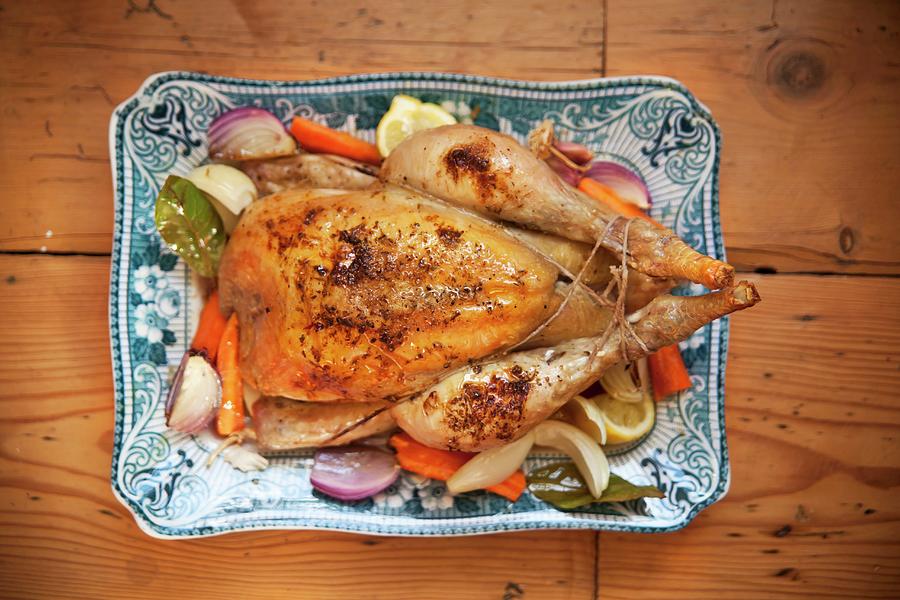 Roast Chicken With Root Vegetables On A Serving Platter Photograph by George Blomfield
