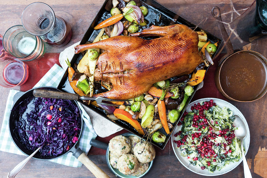 Roast Goose With Oven-roasted Vegetables, Bread Dumplings, Apple Red Cabbage, Creamy Savoy Cabbage And Lingo Berry Compote Photograph by Angelika Grossmann