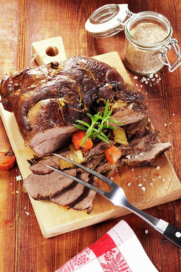 Roast Leg Of Venison With Rosemary, Leek And Carrots Photograph by Bjrn Llf