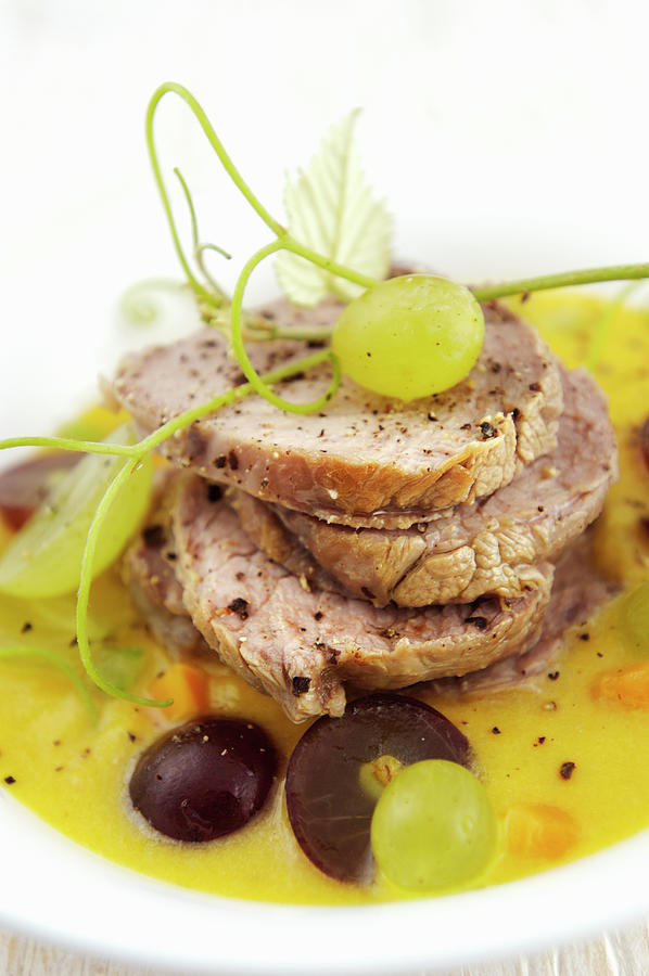 Roast Pork In A Sweet-and-sour Sauce With Grapes italy Photograph by Franco Pizzochero