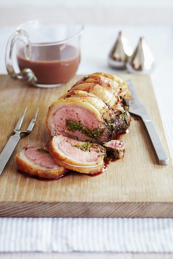 Roast Pork Roulade With Sage, Sliced, On A Wooden Board Photograph by ...