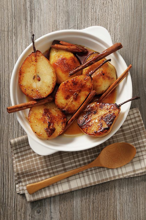 Roasted Caramelised Pears With Cinnamon Sticks Photograph by Jean-christophe Riou