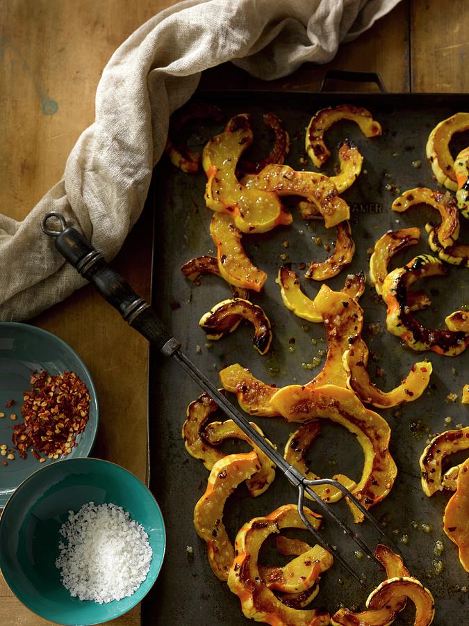 Roasted Carnival Squash On A Baking Tray With Olive Oil And Spices Photograph by Laurie Proffitt