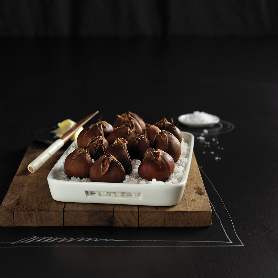 Roasted Chestnuts In Sea Salt Photograph by Hole, Aina C.