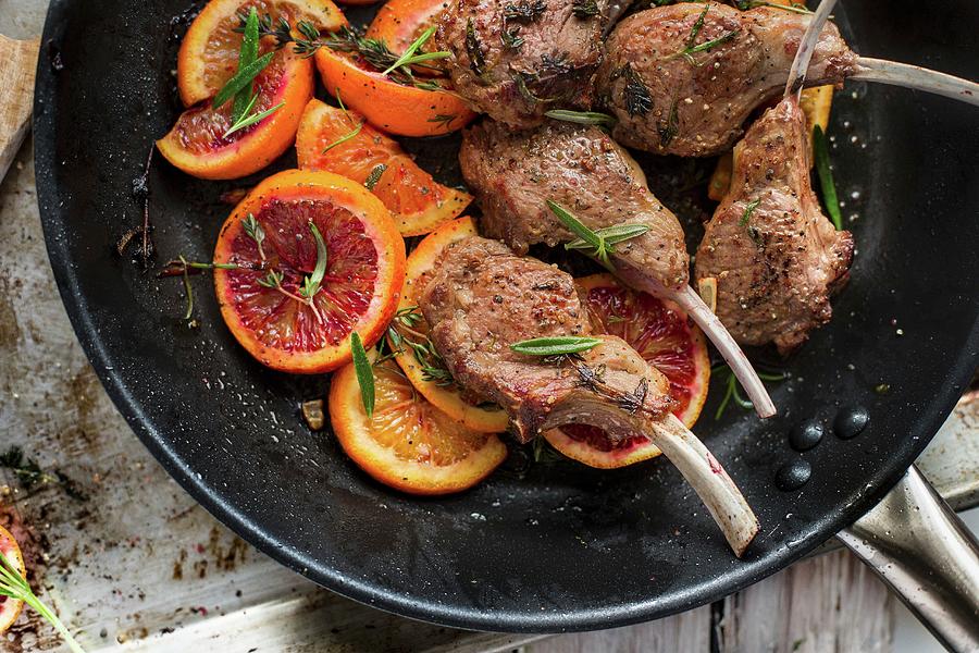 Roasted Lamb Chops With Slices Of Blood Orange And Herbs In A Pan Photograph by Carolina Auer Photography