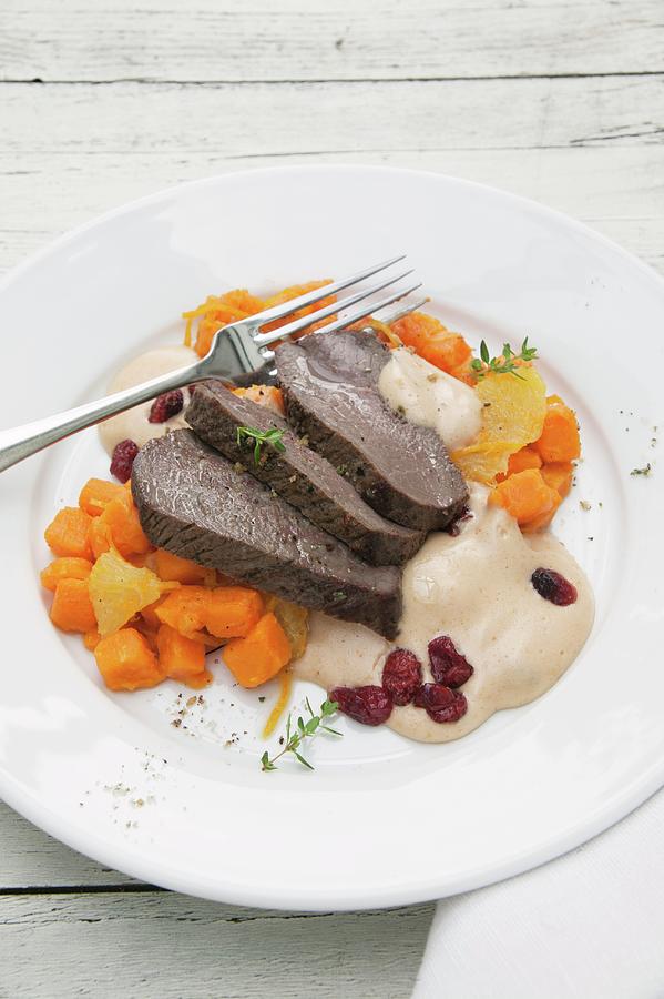 Roasted Leg Of Venison With Cranberry Hollandaise And Sweet Potatoes Cooked With Orange Photograph by Food Experts Group
