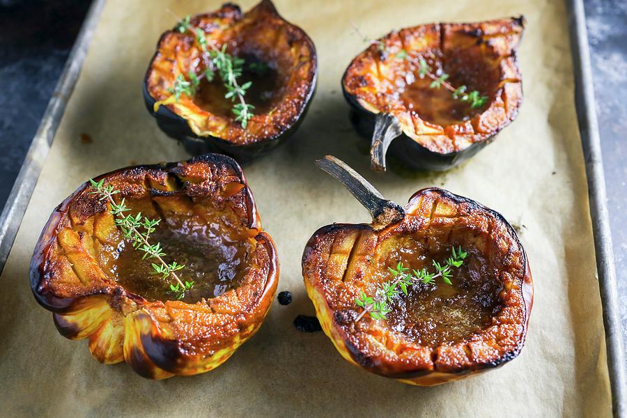 Roasted Pumpkins With Thyme On A Baking Sheet Photograph by Emily Clifton