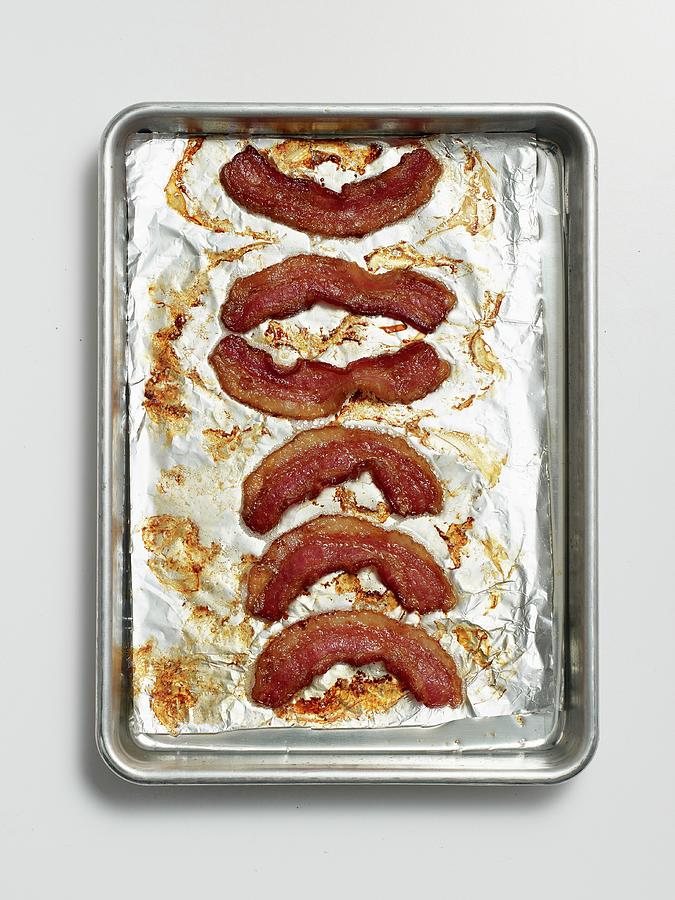 Roasted Rashers Of Bacon On A Baking Tray Lined With Tin Foil Photograph by Clinton Hussey