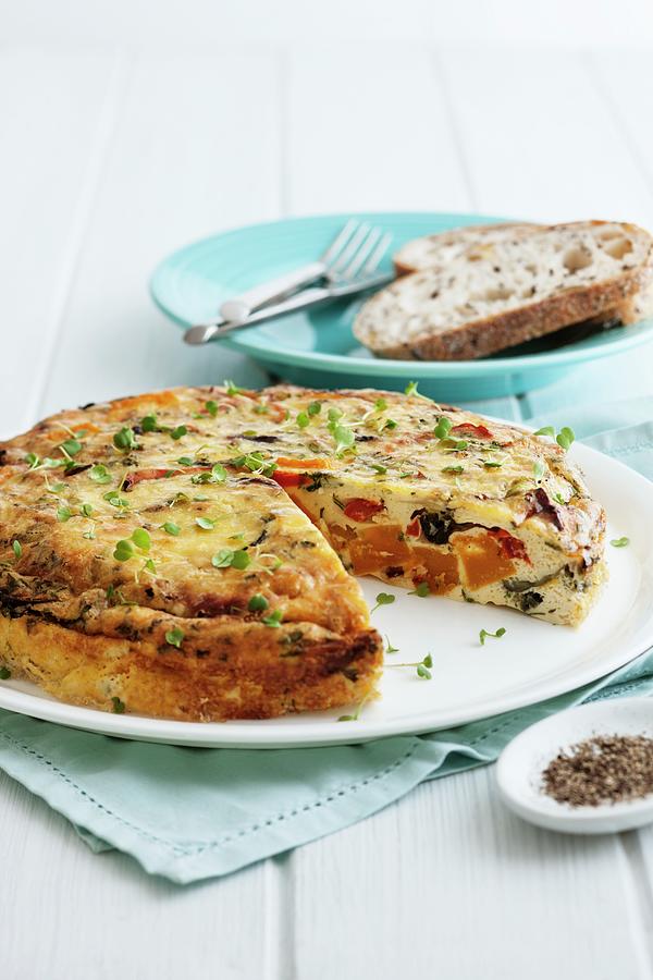 Roasted Vegetable And Olive Frittata, One Slice Removed Photograph by Andrew Young