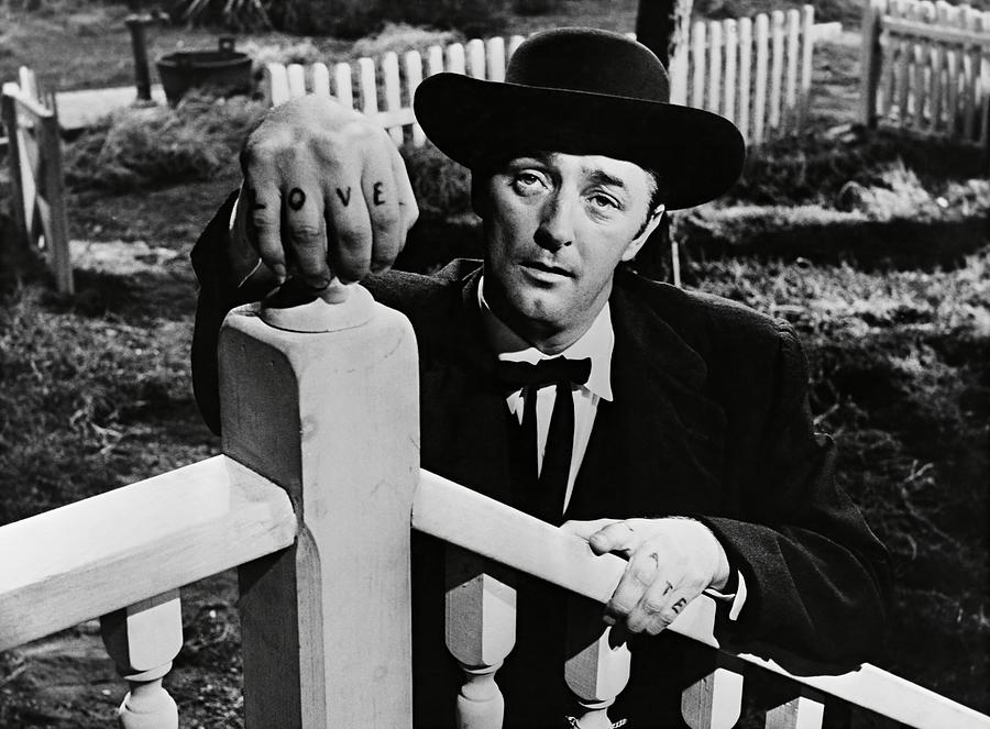 ROBERT MITCHUM in THE NIGHT OF THE HUNTER -1955-. Photograph by Album