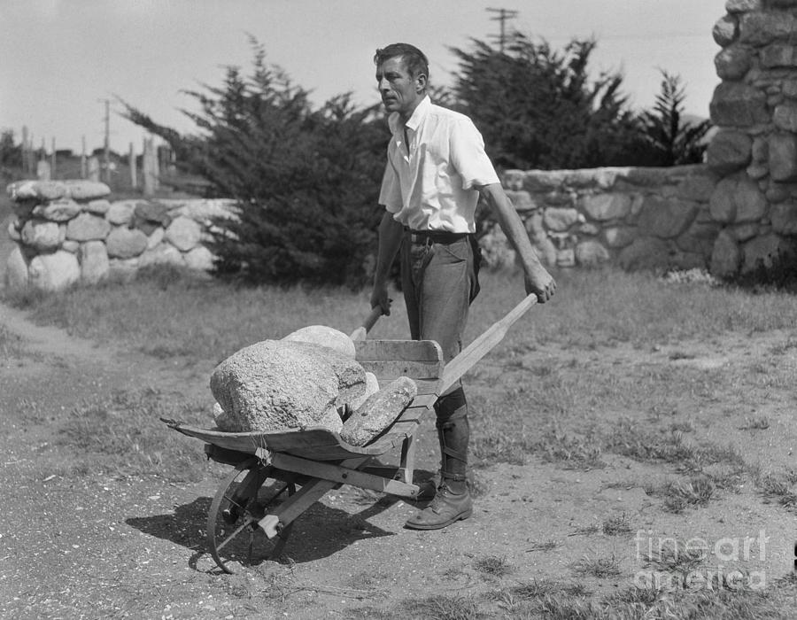 Robinson Jeffers Pushing A Wheelbarrow Photograph by Bettmann