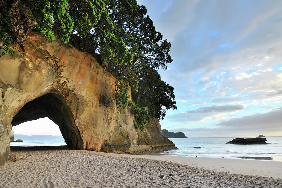 Rock Cave On The Beach Photograph by Raimund Linke