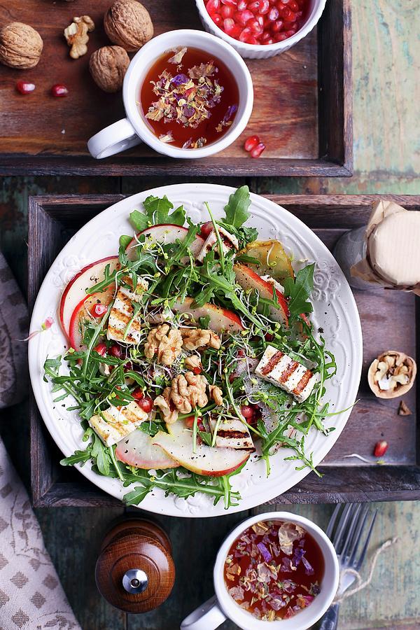 Rocket Fired With Walnuts And Grilled Tofu With Cups Of Tea And Pomegranate Seeds Photograph by Natalia Mantur