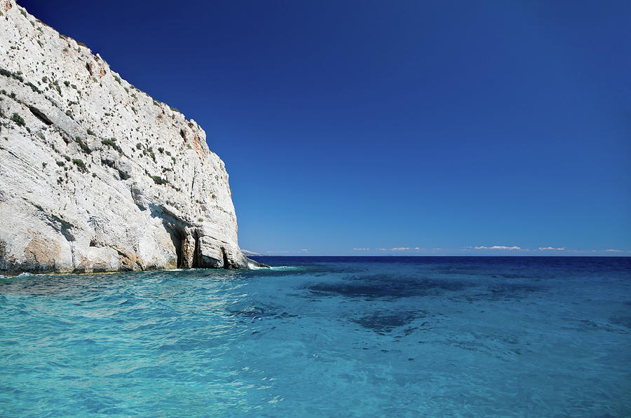 Rocky Cliff On Blue Turquoise Sea Photograph by Aleksandargeorgiev