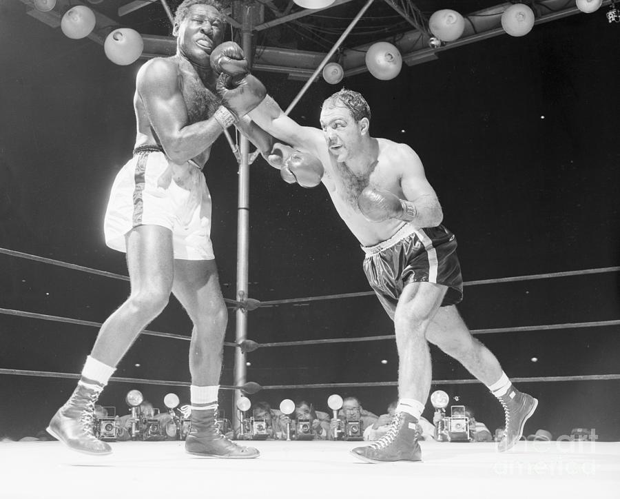 Rocky Marciano Punching Ezzard Charles Photograph by Bettmann