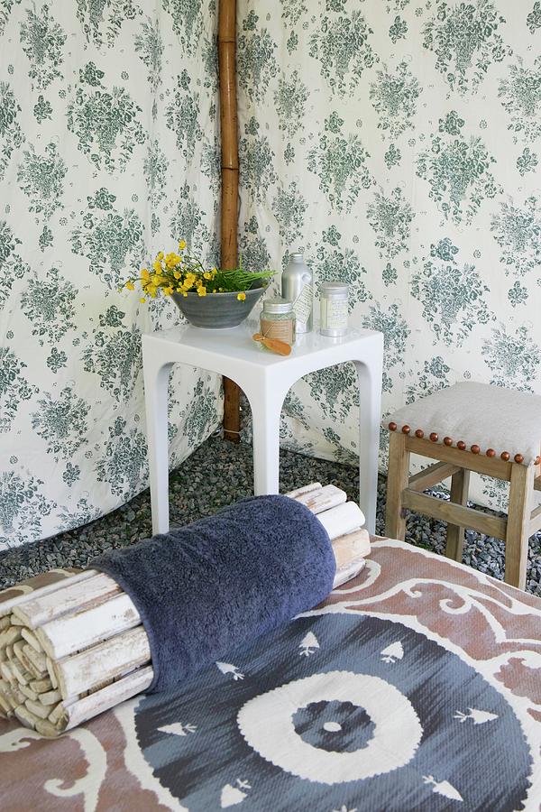 Roll Of Wooden Rods On Lounger And Side Table In Corner Of Tent Made Of Floral Fabric Photograph by Annette Nordstrom