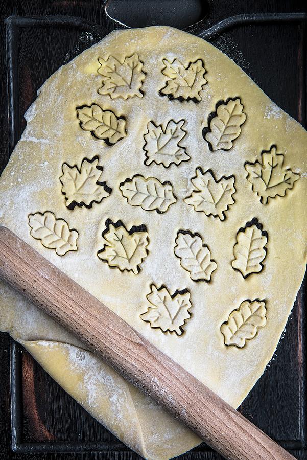 Rolled Out Biscuit Dough With Leaf-shaped Biscuits Cut Out Of It Photograph by Magdalena Hendey