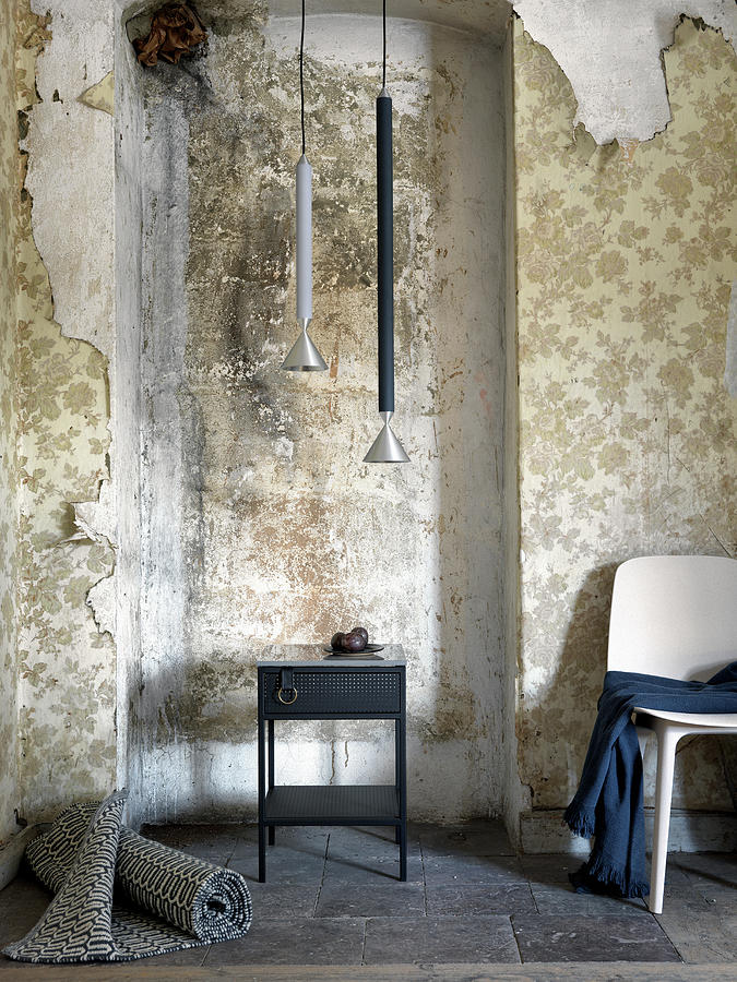 Rolled Rug, Side Table, Pendant Lamps And Chair In Room With Peeling Wallpaper Photograph by Anderson Karl