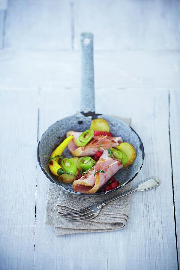 Rolled Smoked Pork Chop With Leeks And Hot Peppers Photograph by Kai Schwabe