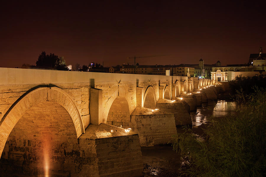 Roman Bridge on Guadalquivir River in Cordoba Photograph by Artur Bogacki