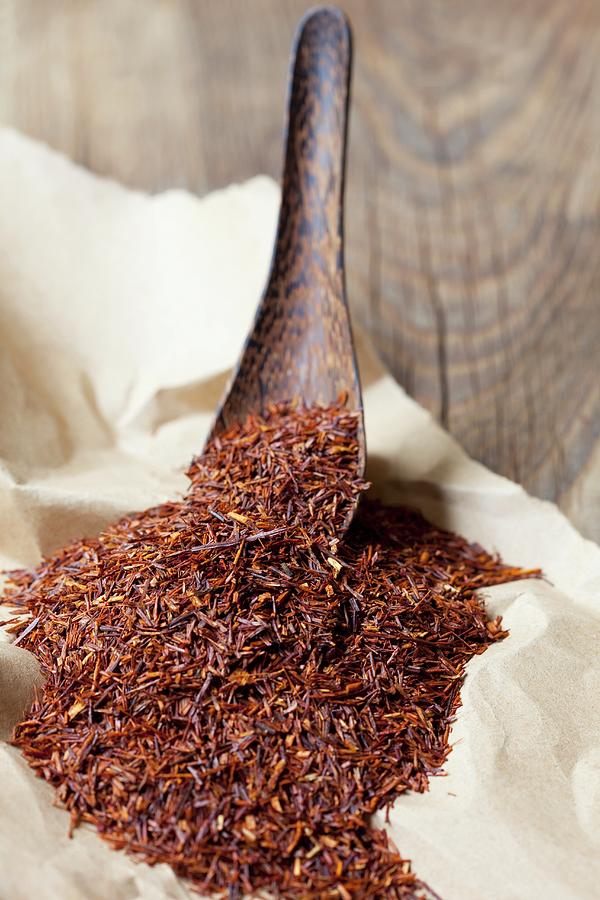 Rooibos Tea Leaves On A Wooden Spoon And On Paper Photograph by Hilde Mche