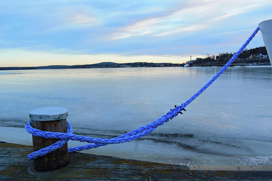 Rope mooring a ship in an ice covered harbor bay Photograph by Intensivelight