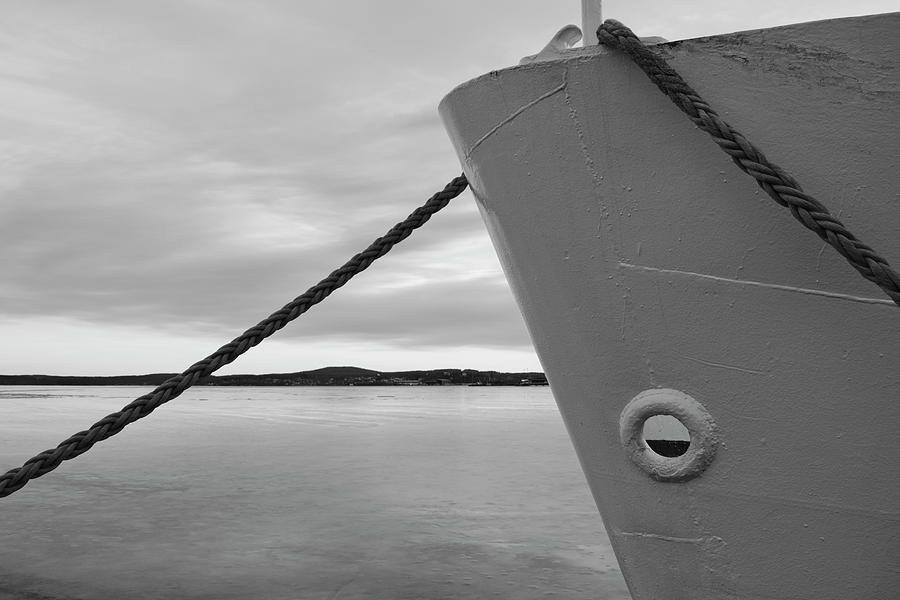 Rope mooring a ship in an ice covered harbor bay - monochrome Photograph by Intensivelight