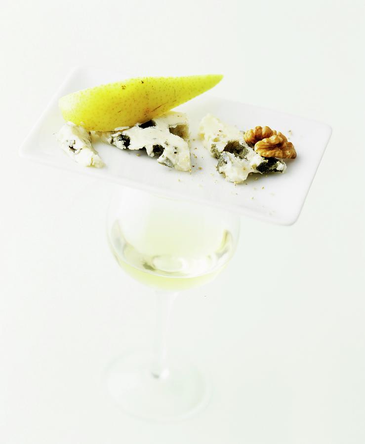 Roquefort With Pear And Walnut On A Plate, With A Glass Of White Wine Photograph by Michael Wissing