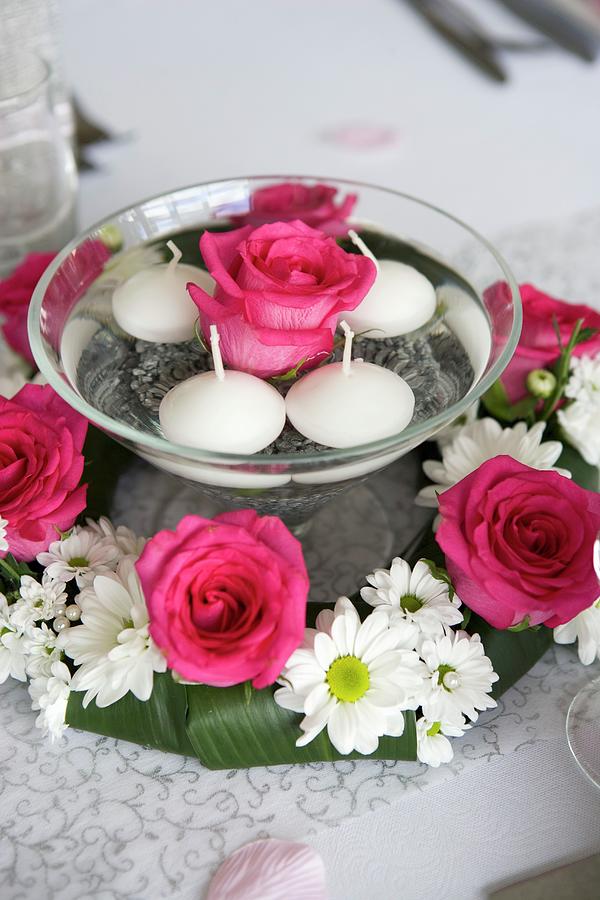 Rose And Floating Candles In Bowl Of Water Surrounded By Wreath Of Roses And Ox-eye Daisies Photograph by Lydie Besancon