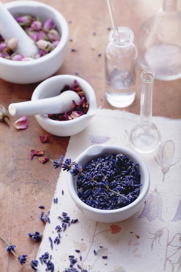 Rose And Lavender Flowers With Mortar And Apothecary Bottles Photograph by Foodcollection