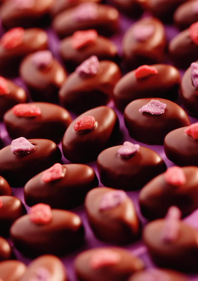 Rose And Violet Cream Chocolates On A Lilac Background Photograph by Jonathan Pollock
