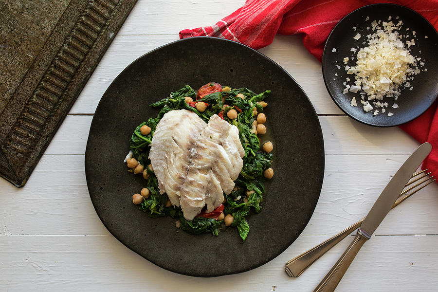 Rose Fish On A Bed Of Spinach With Chickpeas, Tomatoes And Cumin Photograph by Nicole Godt
