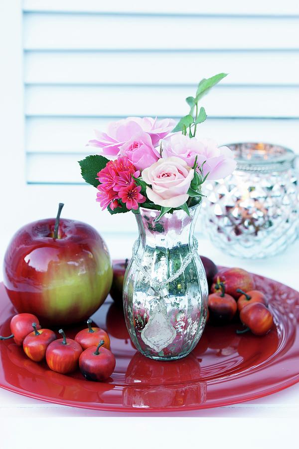 Rose In Mercury Glass Vase And Apple Ornaments On Red Plate Photograph by Angelica Linnhoff