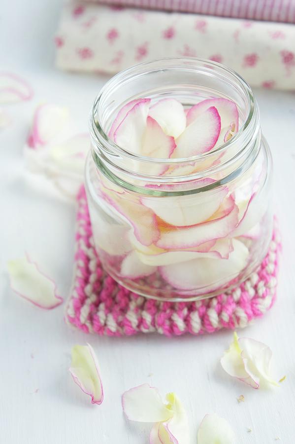 Rose Petals In A Jar On A Pan Holder Photograph by Martina Schindler