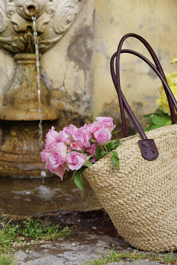 Roses In Raffia Basket Photograph by Angelica Linnhoff